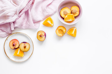tropical peach and orange fruits for fresh juice with towel white background top view space for text