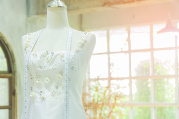 Mannequin in white wedding dress in studio shop