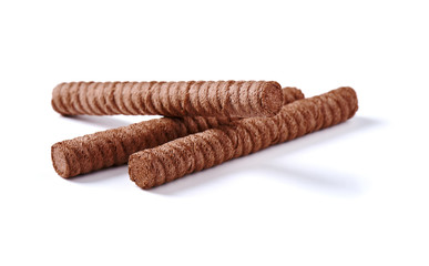 Chocolate wafer rolls with butter and cocoa filling on a white background