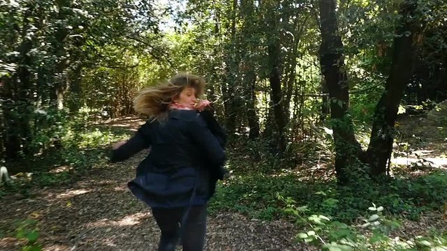 Scared terrified Woman Running Away From somebody Into Forest- slow motion