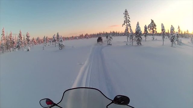 Riding snowmobile through Swedish wilderness, point of view