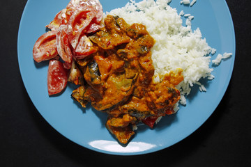 closeup of indian food with rice and tomato salad