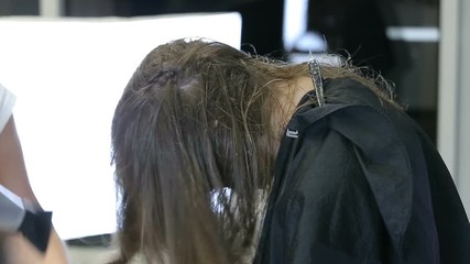 Professional Hair Dresser dries hair of teen cute girl