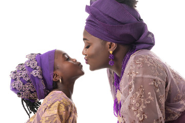 Mother and child girl kissing.African traditional clothing .Isolated