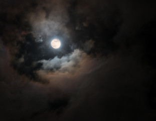 Fototapeta na wymiar Full Moon among colorful swirling clouds