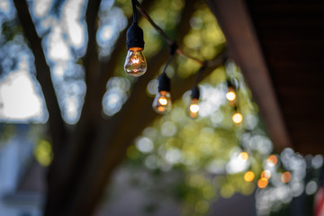 string of clear retro style Edison party lights outside in summer