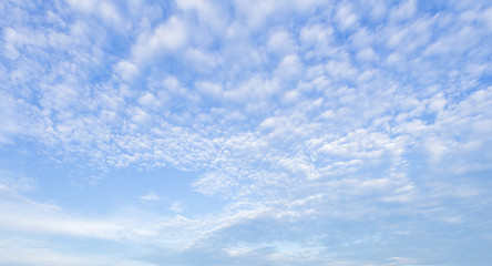 The sky is blue, there are a lot of small clouds to use as a background image.