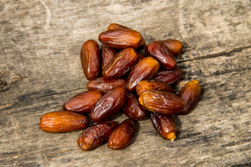 Dried date fruits on wooden background. Top view