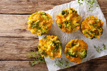 Broccoli Muffins with cheddar cheese and thyme close-up on the table. Horizontal top view
