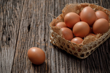 Egg in a basket on wooden table, Chicken Egg