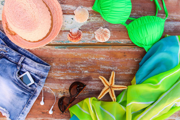Summer women's clothing and accessories: hat, bathing suit, denim shorts, pareo, sunglasses, mobile...