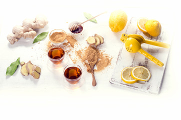 Tea with lemon and ginger on a wooden background