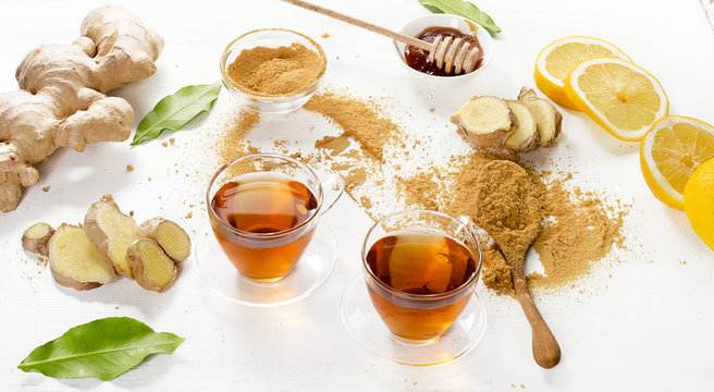 Tea with lemon and ginger on a wooden background