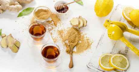 Tea with lemon and ginger on a wooden background