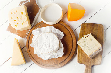 Cheese on  white wooden table.