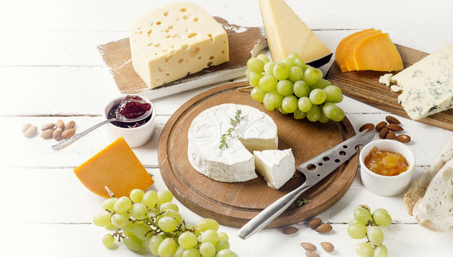 Different kinds of cheeses on a wooden table