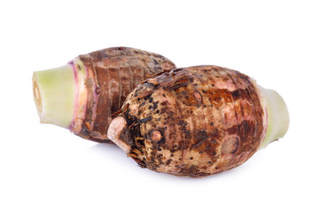 whole raw taro on white background