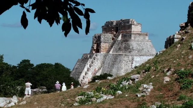 Tourists taking photos of Great pyramid at archaeological site Uxmal, Yucatan, Mexico