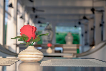 Red roses made of cloth in terracotta vases