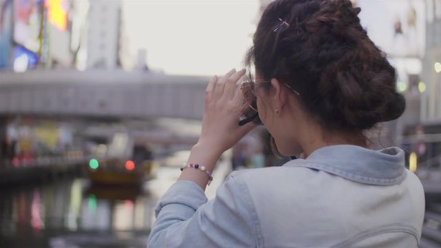 Young women using DSLR camera photos in Namba Bridge Japan
