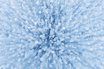 Gas bubbles texture in ice of lake. Winter background