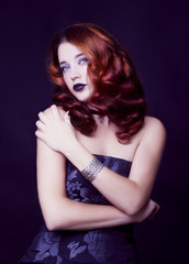 Naklejka premium Pretty female fashion model posing in studio with dark gothic make up