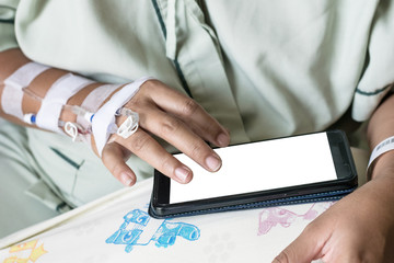 asia woman in hospital room on bed sick and injured is using mobile phone. blank display for graphic designer