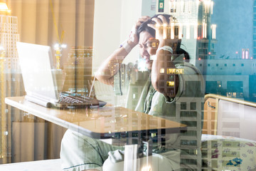 the asia woman in hospital room in bed sick and injured feeling angry and serious about her job after looking for display on computer laptop. Double Exposure procesing