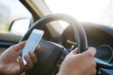 Man texting message in a car
