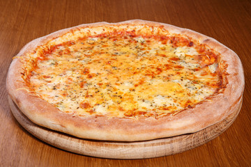 Italian pizza on the table, pepperoni, spices, tomatoes, cheese