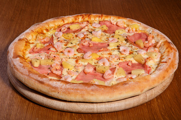 Italian pizza on the table, pepperoni, spices, tomatoes, cheese