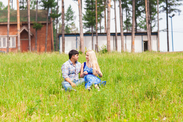 young couple sitting on grass and relaxing