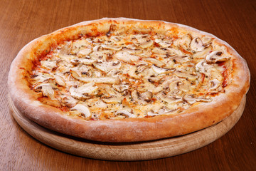Italian pizza on the table, pepperoni, spices, tomatoes, cheese
