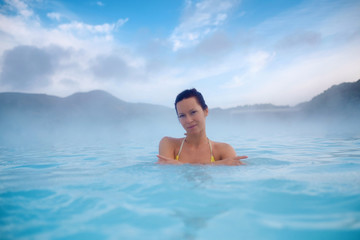 Woman enjoys spa in geothermal hot spring