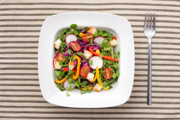 Homemade fresh green vegetable salad on table.
