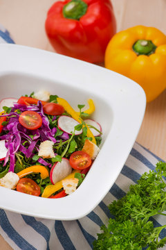 Homemade fresh green vegetable salad on table.