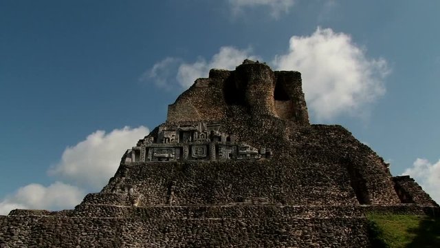 White clouds rolling over the top of temple El Castillo at Xunantunich, Belize