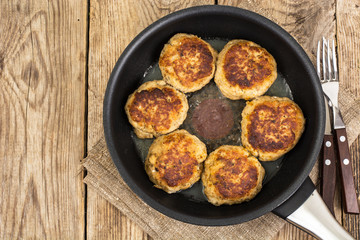 Tasty fried chops in frying pan