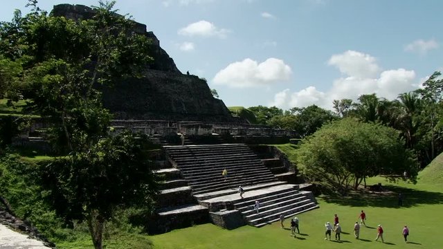 Tourists coming towards temple El Castillo at Xunantunich archaeological site in Belize