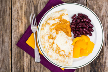 Omelette in plate, sweet yellow pepper