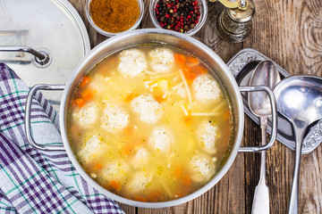 Soup with meatballs in metal pan