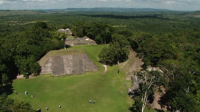 Elevated shot of people on the ground from temple El Castillo at Xunantunich archaeological site in Belize