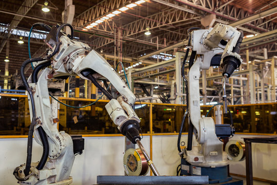 Industrial robot are test run new program in automotive assembly factory