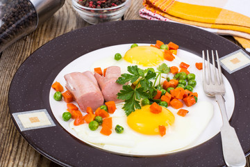 Plate with fried eggs and steamed vegetables for breakfast