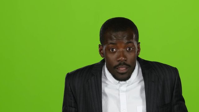 African american is indignant, he is angry and aggressive. Green screen. Slow motion. Close up
