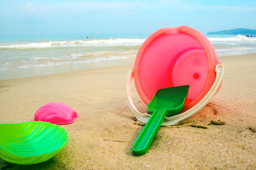 Children's pail and colored molds on the beach in the sand