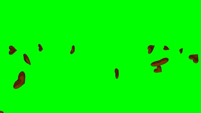 Animated exploding, dancing a chocolate hearts against green background in 4k.