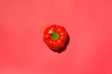 Top view of red bell pepper on red background.