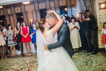 First wedding dance of newlywed. Confetti around.