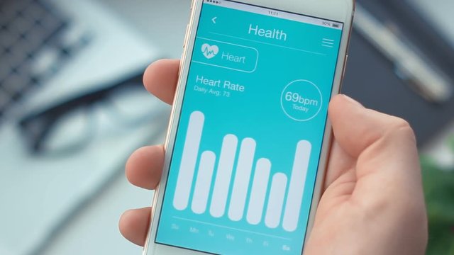 Smartphone app. Checking heart rate monitoring on health app on the smartphone